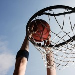 Close-up of basketball player dunking a ball