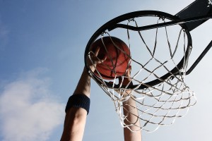 Close-up of basketball player dunking a ball